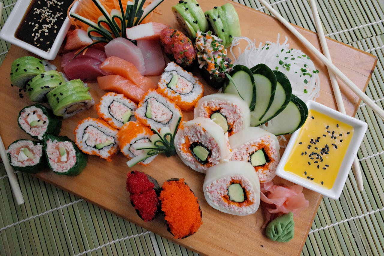Colorful sushi platter with assorted rolls and dipping sauces, perfect for a gourmet meal.